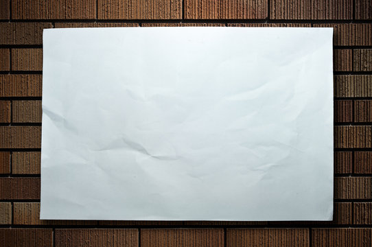 wrinkled paper on brickwall