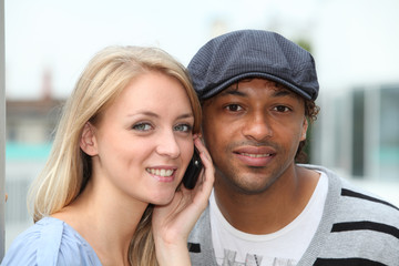Closeup of young couple with telephone
