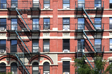 Naklejka premium facade of old house with fire escape in New York