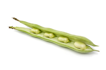 Fresh green broad beans in an open pod