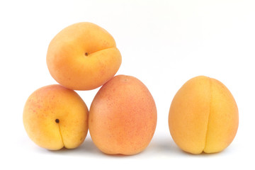 Four ripe apricots isolated on white background