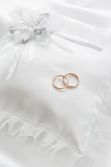 Wedding rings on a white pillow