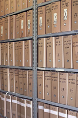 Archive with many folders on a metal shelf