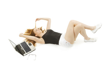 Young woman relaxing on the floor with laptop