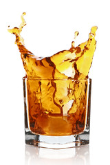 Glass with splashing whisky drink