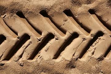industrial tractor footprint on beach sand