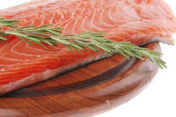 big salmon fillet on wood with rosemary