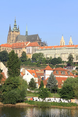 Obraz premium The View on summer Prague above River Vltava with gothic Castle