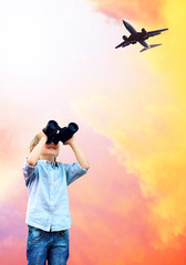 Obraz premium Young boy watch in the field-glass under sky