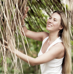 Beautiful young woman outdoors in the summer day.