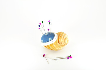 pincushion in shell with pins
