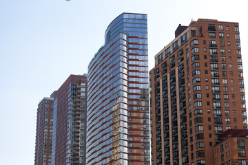 facade of modern apartment building with reflection of blue sky