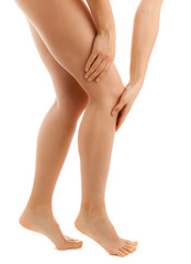 Woman massaging pain knee on white background