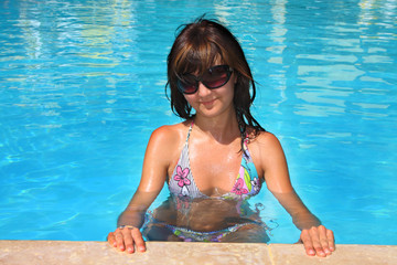 Young active woman on a pool