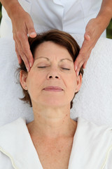 Fototapeta na wymiar Senior woman having a face massage