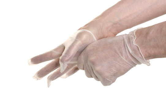 Doctor pulling on surgical glove isolated over white