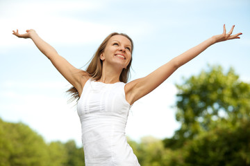 Portrait of the beautiful young woman in park