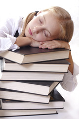 Teen girl in school uniform sleeping on thick books