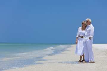 Happy Senior Couple Looking To Sea on A Tropical Beach