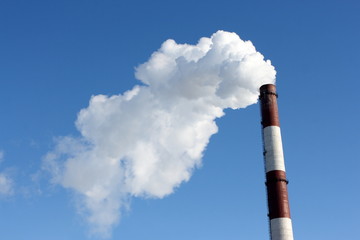 Smoking stack of thermal power station against a blue sky