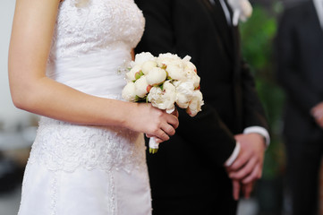 Bride holding white wedding bouquet