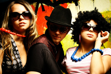 Fashion young guys and girls sitting together and having fun