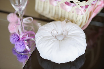 Two wedding rings on a pillow