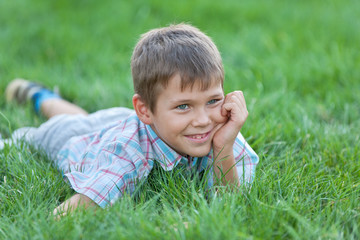 Handsome boy on the green grass