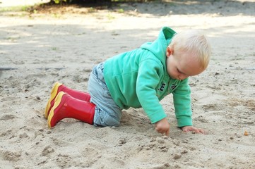 Child playing within sand