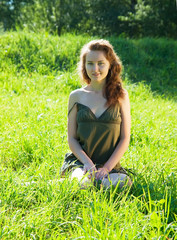 Fototapeta premium Pretty girl in grass outdoor