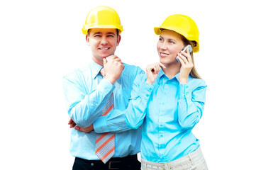 Young architects wearing a protective helmet standing on the bui