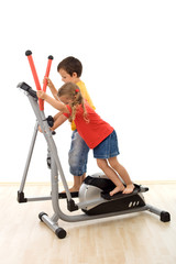 Teamwork - kids playing on elliptical trainer