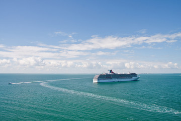 Fototapeta na wymiar Boats Circling Cruise Ship on Blue Sea