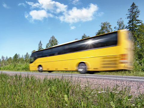 Yellow Tourist Bus Speeding On Rural Highway, Motion Blur,