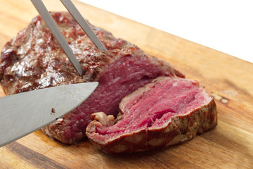 roasted meat on a cutting board. isolated object