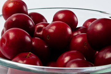 Glass bowl with ripe plum