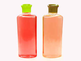 two red and pink fruit shampoo bottles