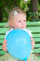 Fototapeta premium Little girl with blue air balloon