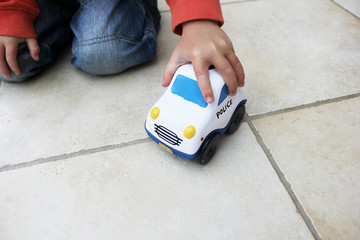 boy playing with toy police car © jojof