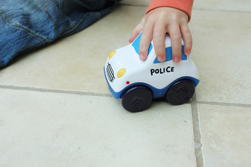 boy playing with police toy car