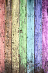 aged rainbow painted wooden fence, naturally weathered