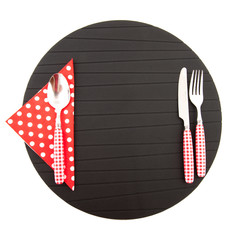 Place mat with red cutlery