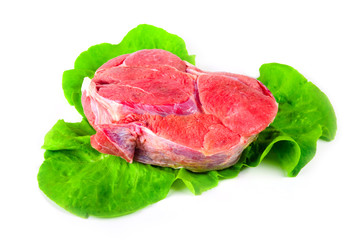 Cow Meat with green leaves on white background