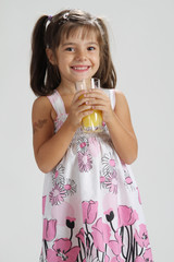 cute girl holding a glass of orange juice