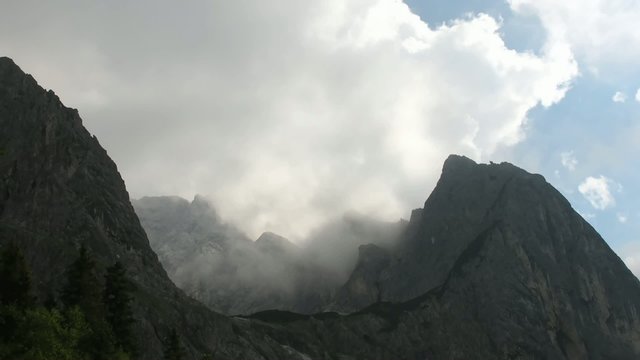 Time lapse clouds over mountains around gorge Hoellentalklamm