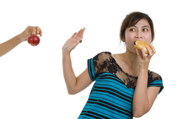 woman with hamburger refusing an apple