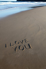 I love you written in the sand at the beach