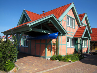 wooden house with carport and boat