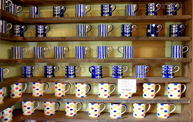 many coffee cup on wood shelf background