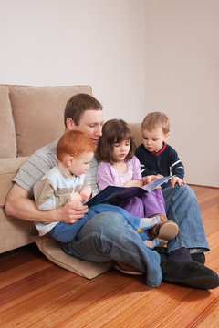 Dad Reading Story To Kids